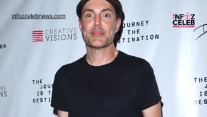 James Haven posing at a public event in a black shirt and cap